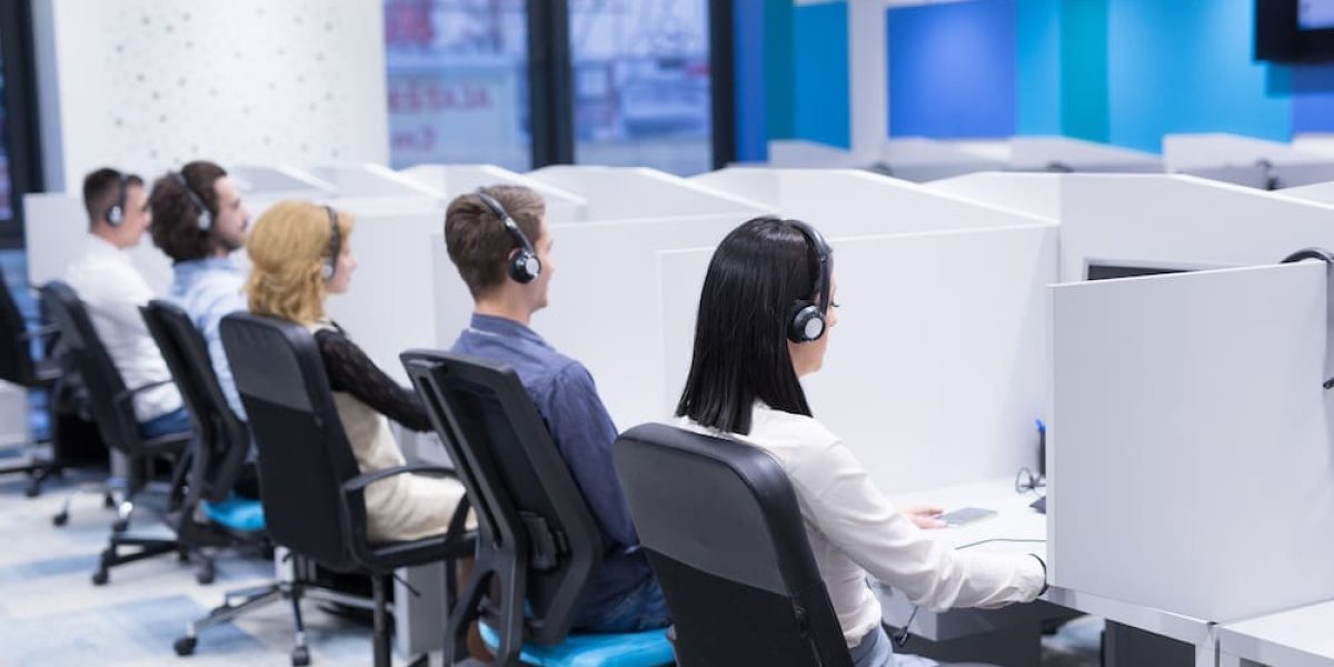 group of young business people with headset working and giving support to customers in a call center office